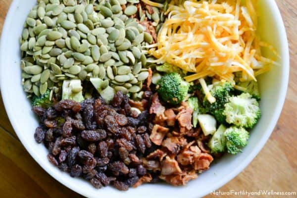 Creamy broccoli salad ingredients in bowl