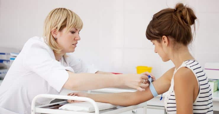 woman taking blood for test